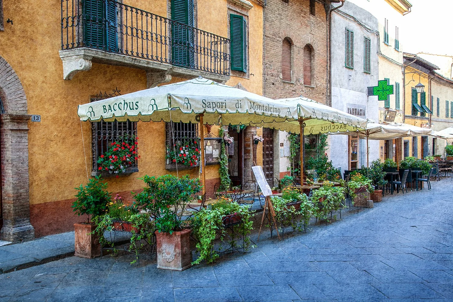 Outdoor Italian restaurant with tables and umbrellas
