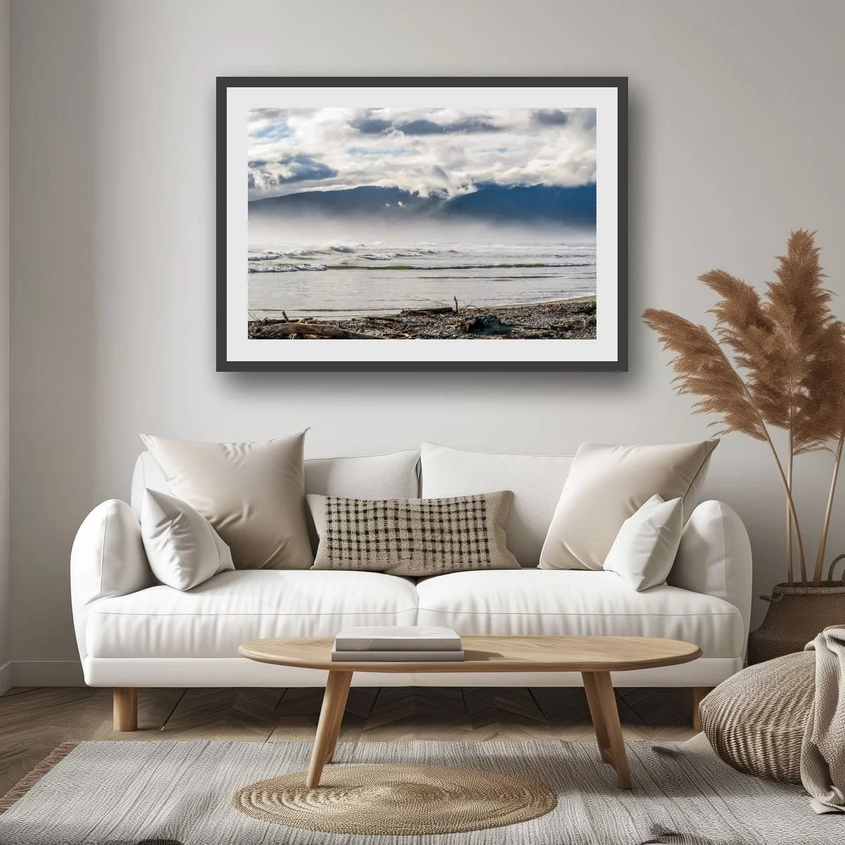 Layered mountain ranges fading into soft light beside the coast.