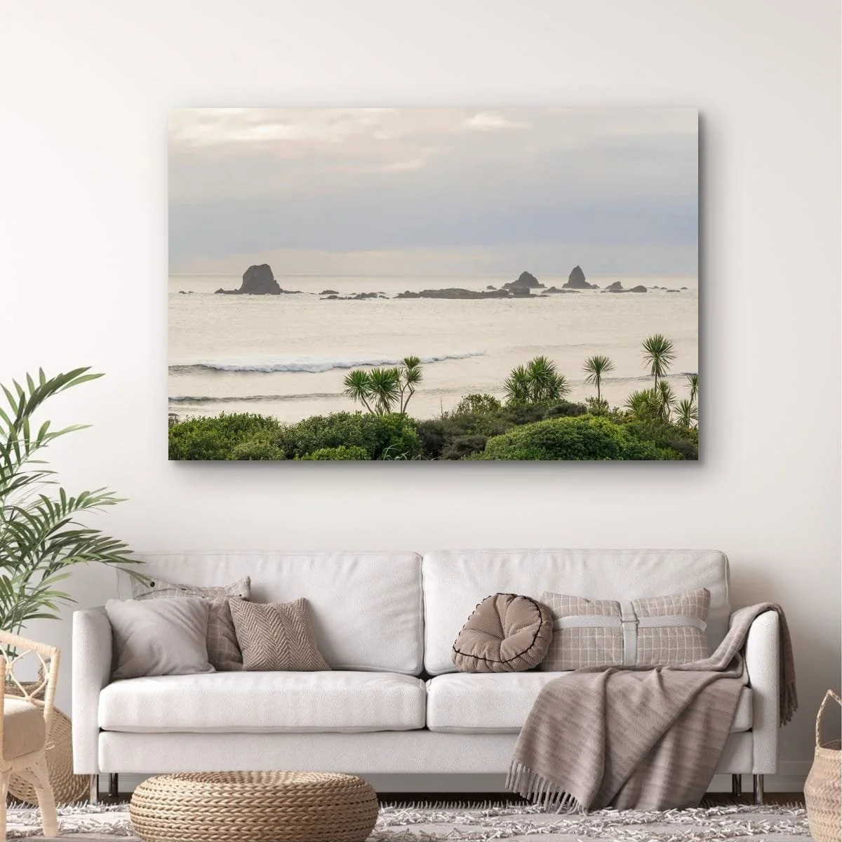 Morning light over sea stacks framed by native coastal plants.