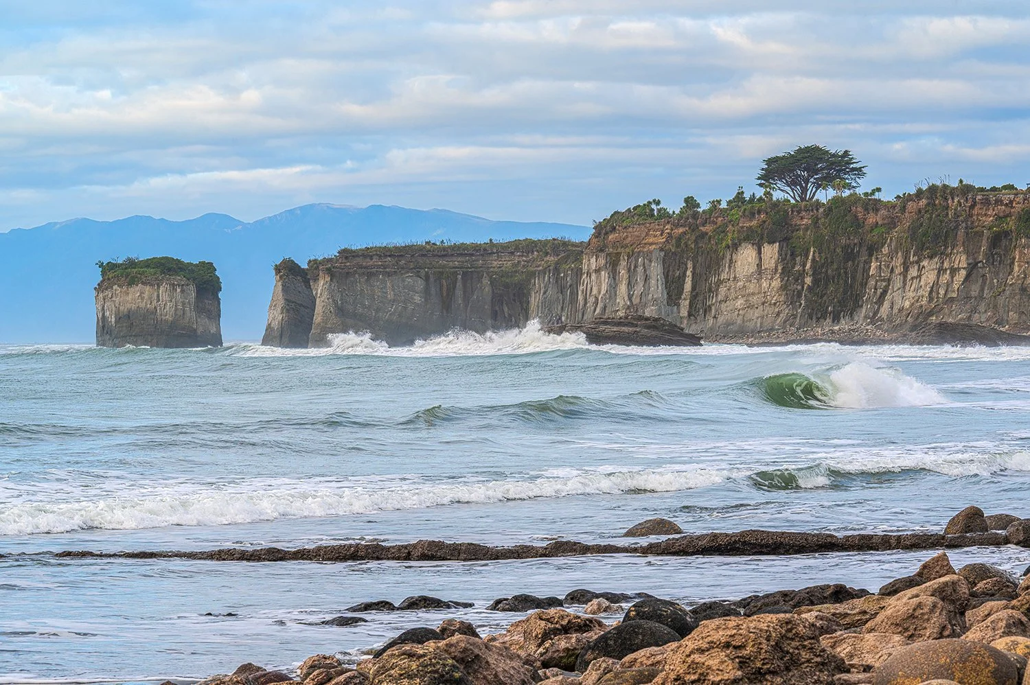 Rolling waves beneath soft skies on the West Coast.