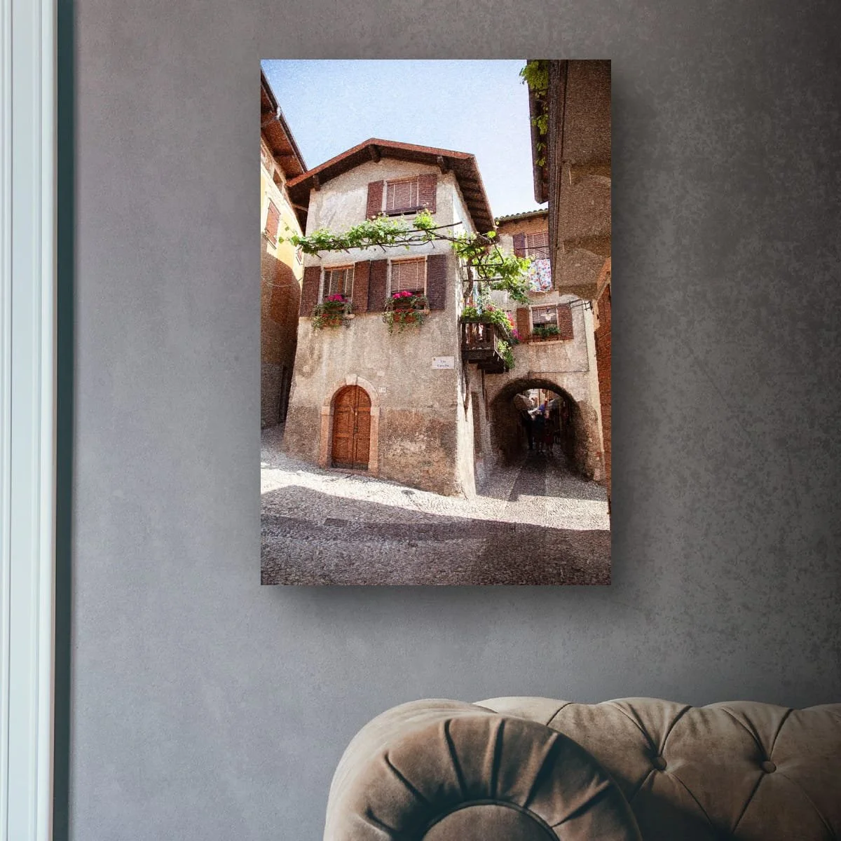 Historic Italian laneway with balconies, flowers and stone archways.