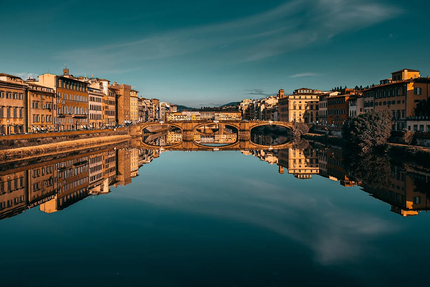 Florence cityscape reflected in the Arno River.