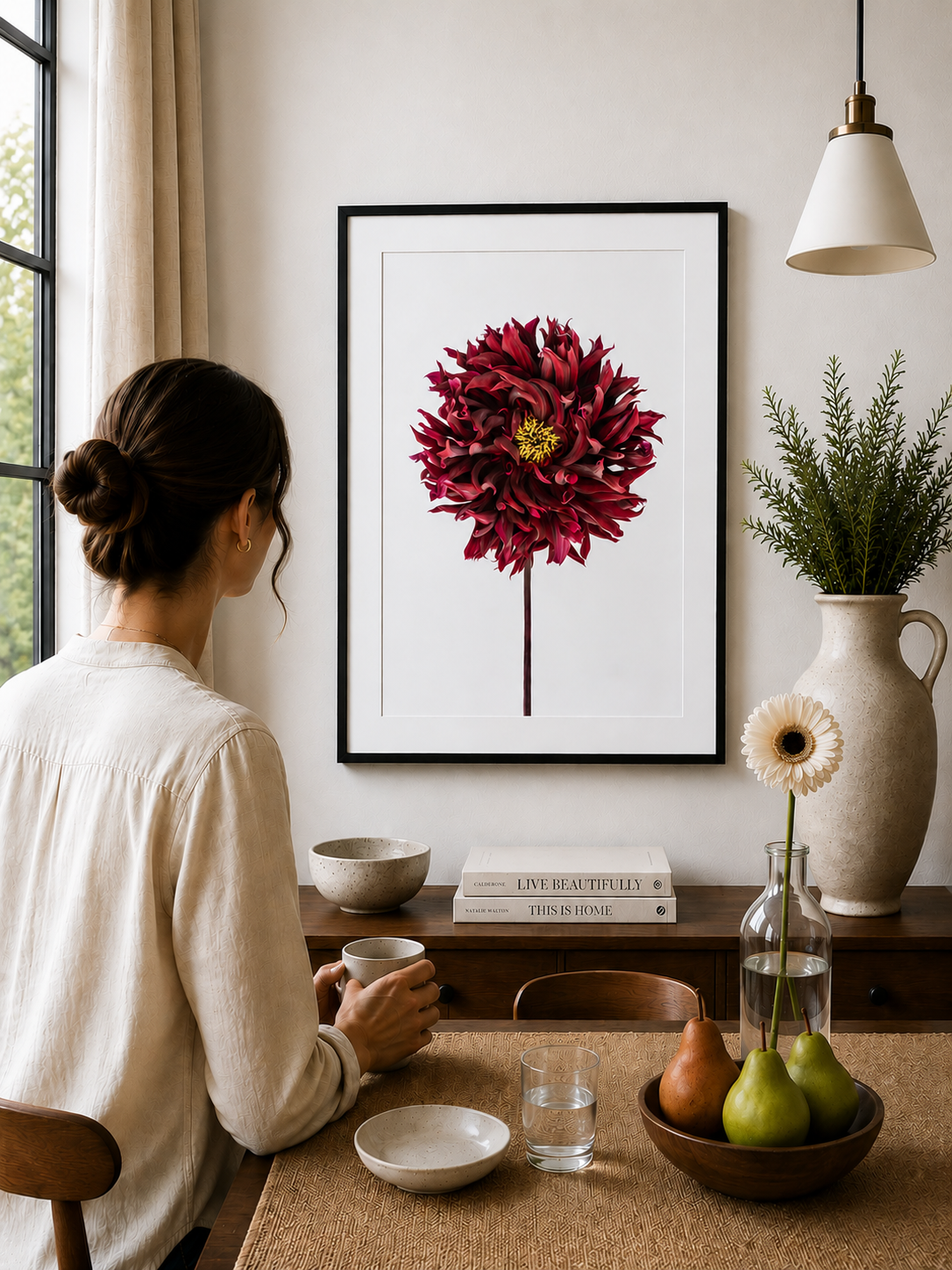 Deep red dahlia flower with layered petals on a soft white background.