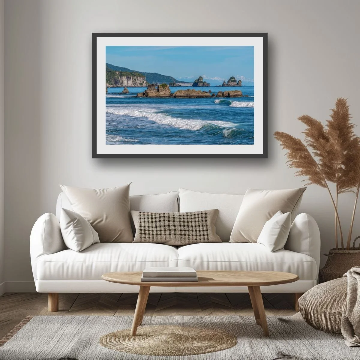 Coastal rocks, ocean and distant snow-capped mountains.