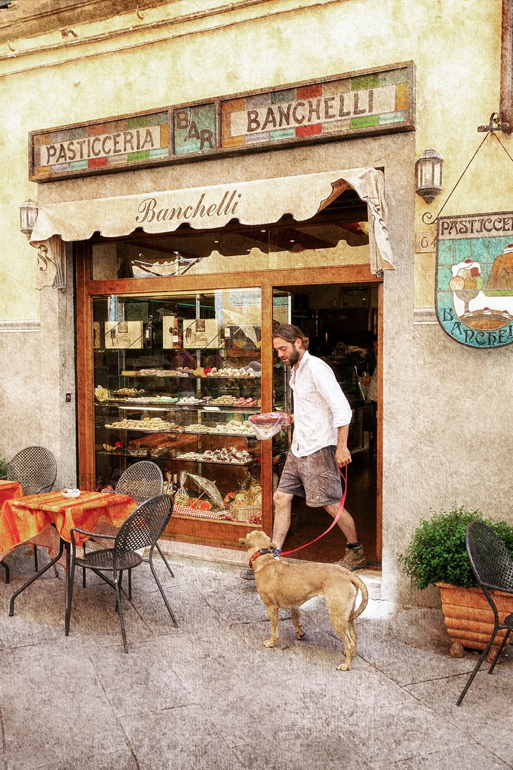 Italian café courtyard with tables and warm architecture.