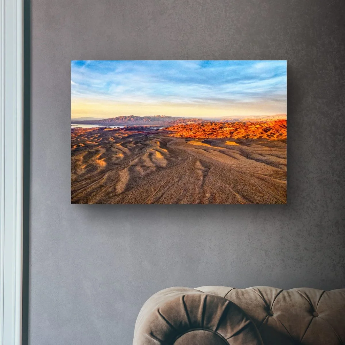 Aerial view of flowing desert ridges and mountains.