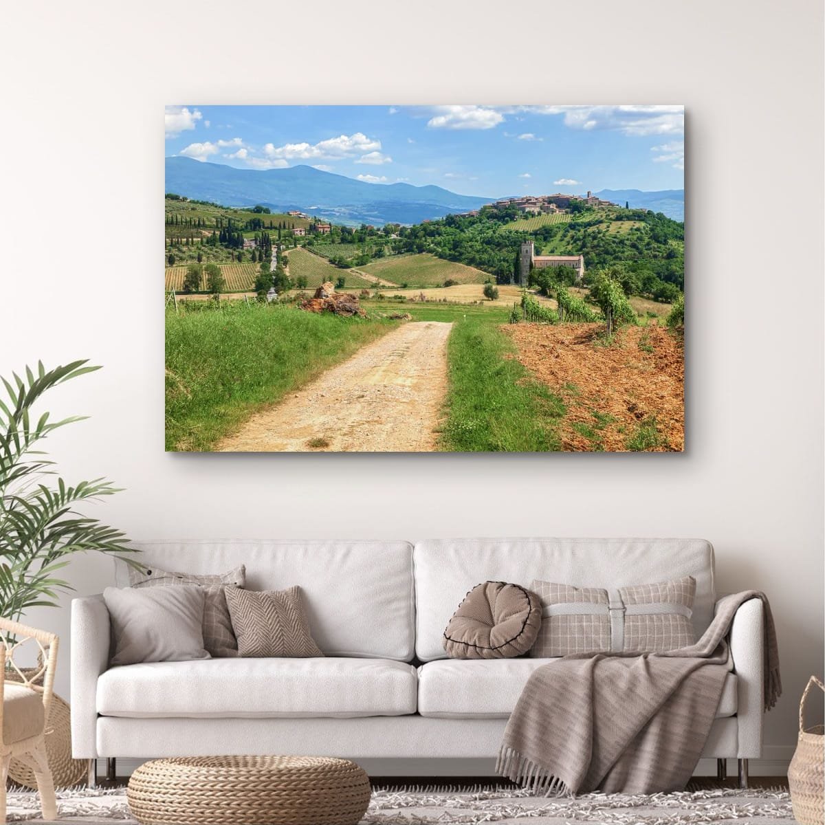 Rolling Tuscan hills with vineyards and historic hilltop village.