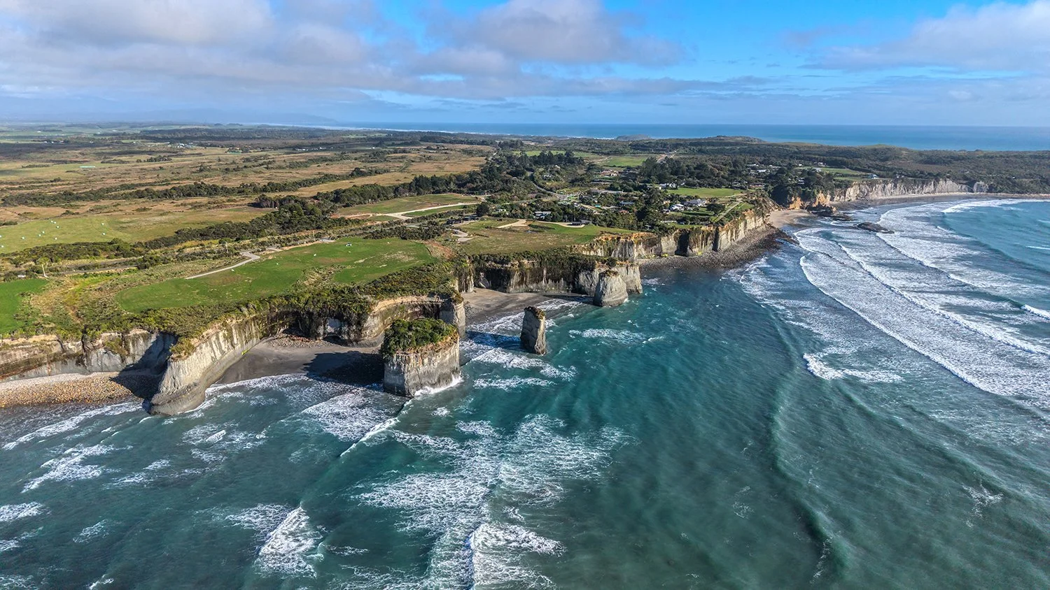Aerial photograph of rugged coastal cliffs and ocean on New Zealand's West Coast.