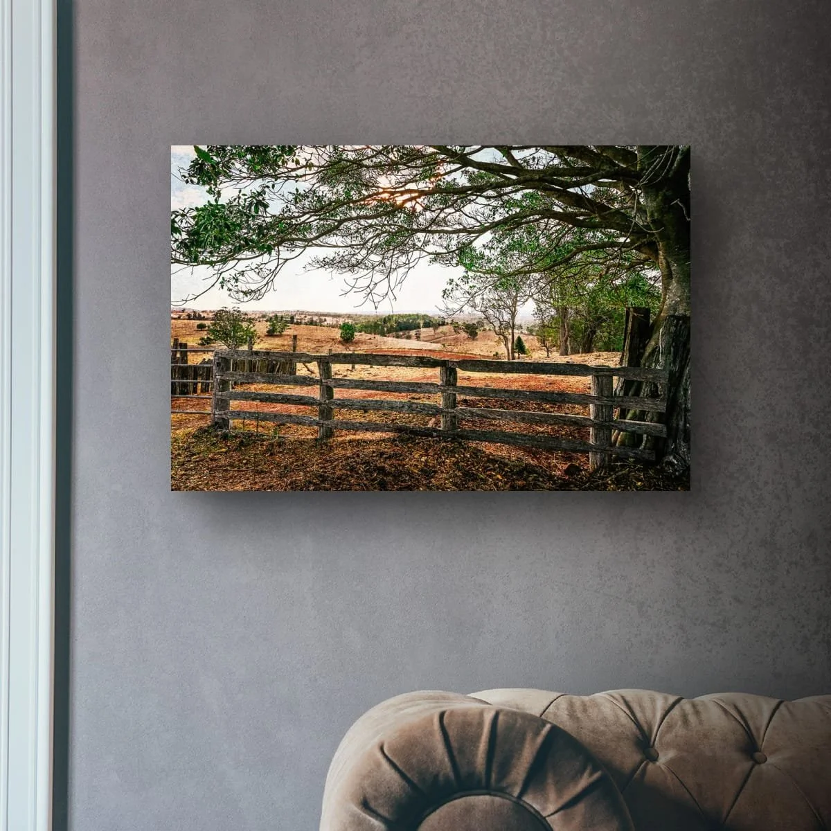 Weathered timber fence overlooking rolling rural hills.