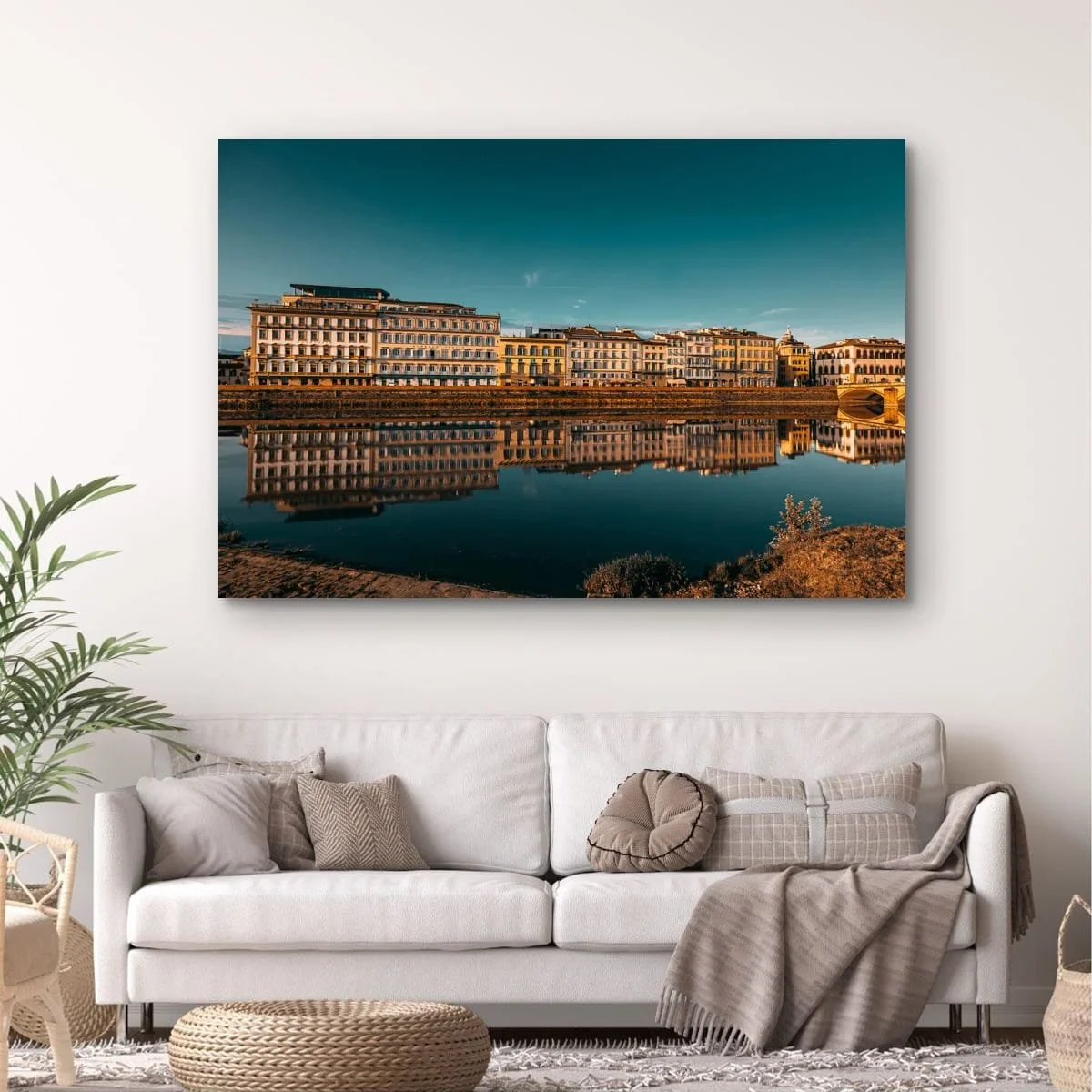Florence buildings reflected in the Arno River at sunset.