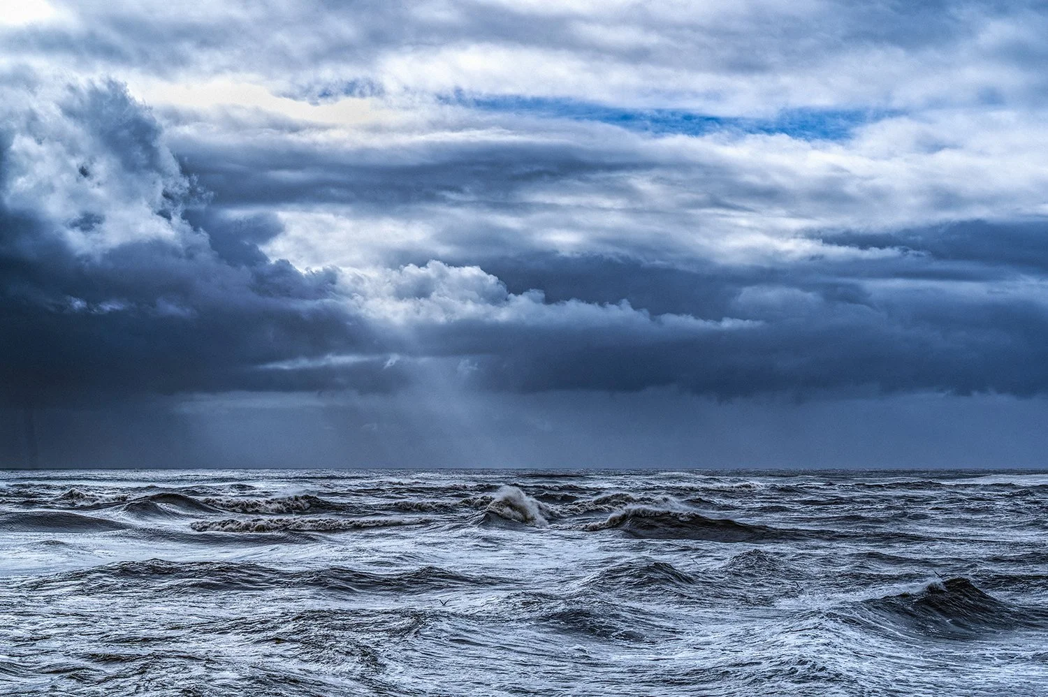 Storm clouds and dramatic light over the ocean.