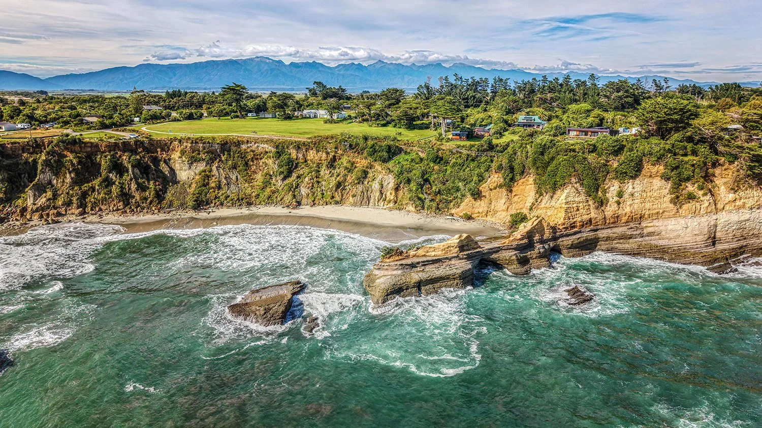 A view of Cape Foulwind coastline with reefs and ocean swells.