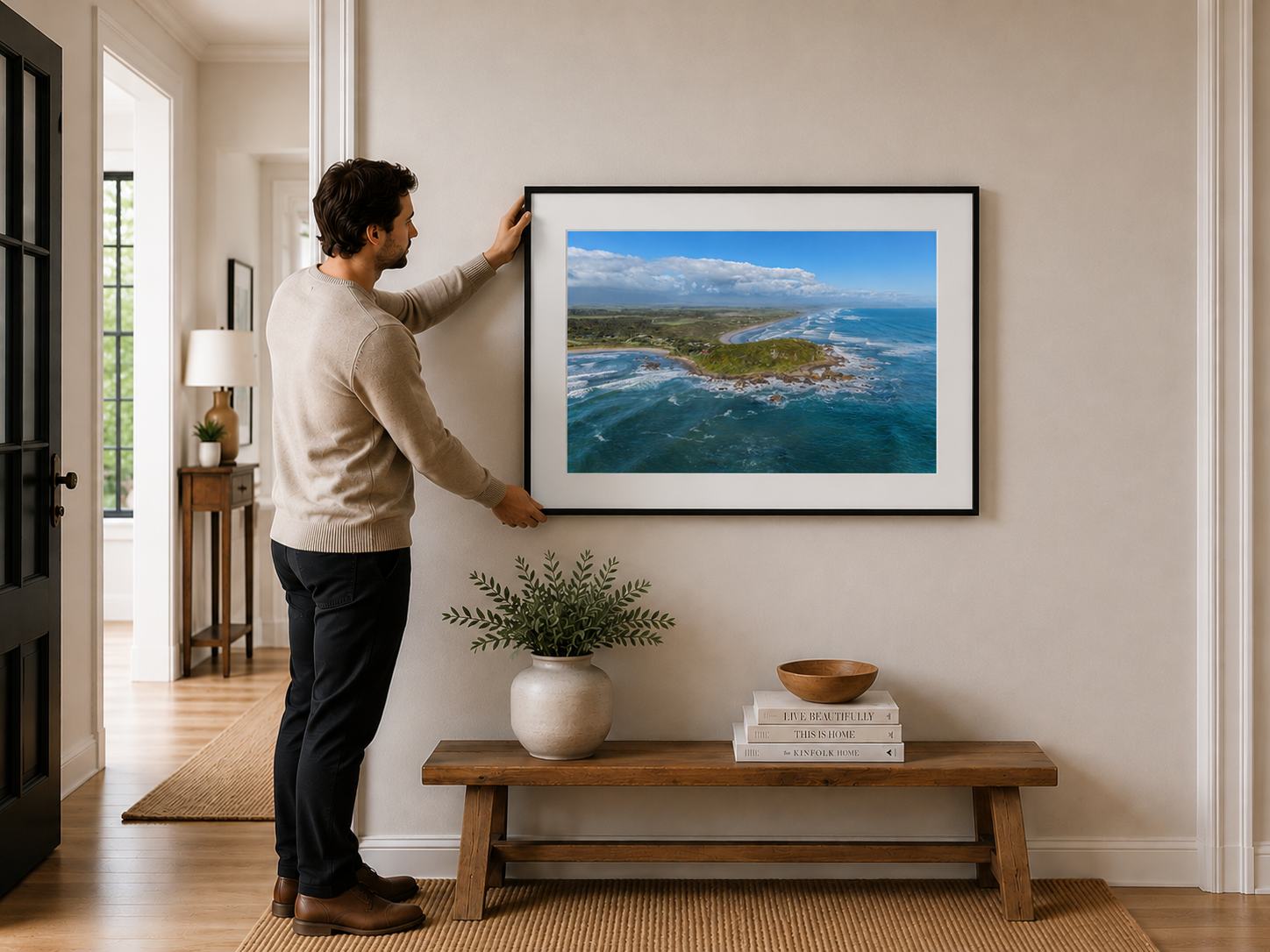 Aerial view of rugged West Coast shoreline and rolling ocean waves.