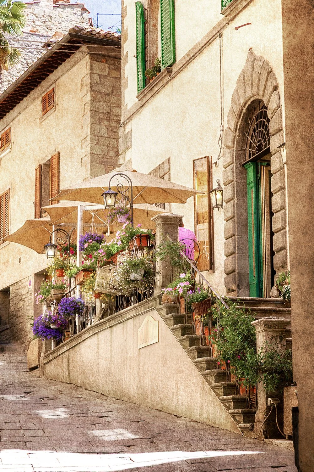 Flower-filled entrance to a Tuscan osteria in morning light.