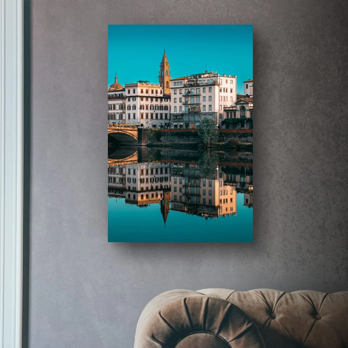 Tuscan buildings and church reflected in calm water.