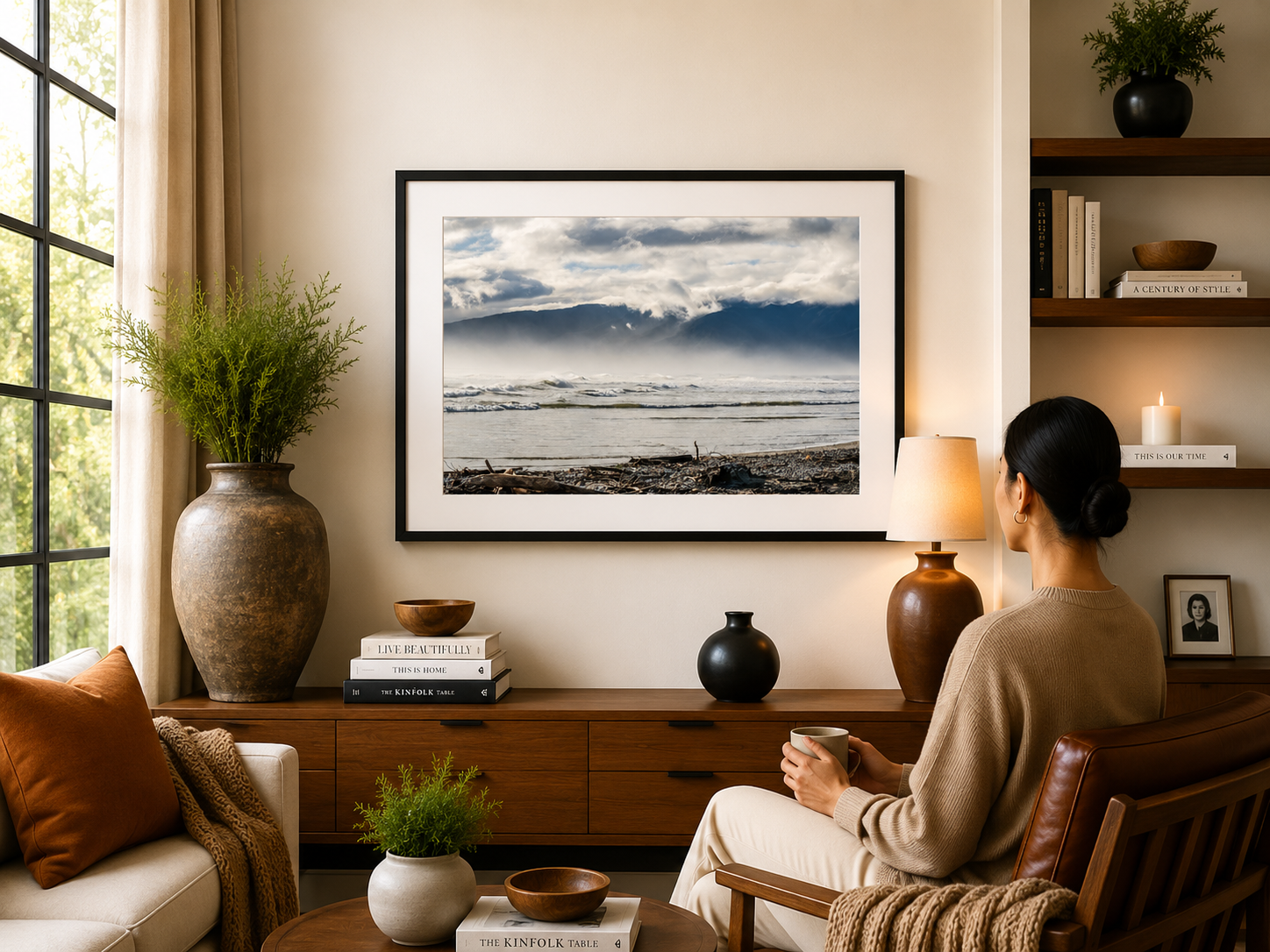 Layered mountain ranges fading into soft light beside the coast.
