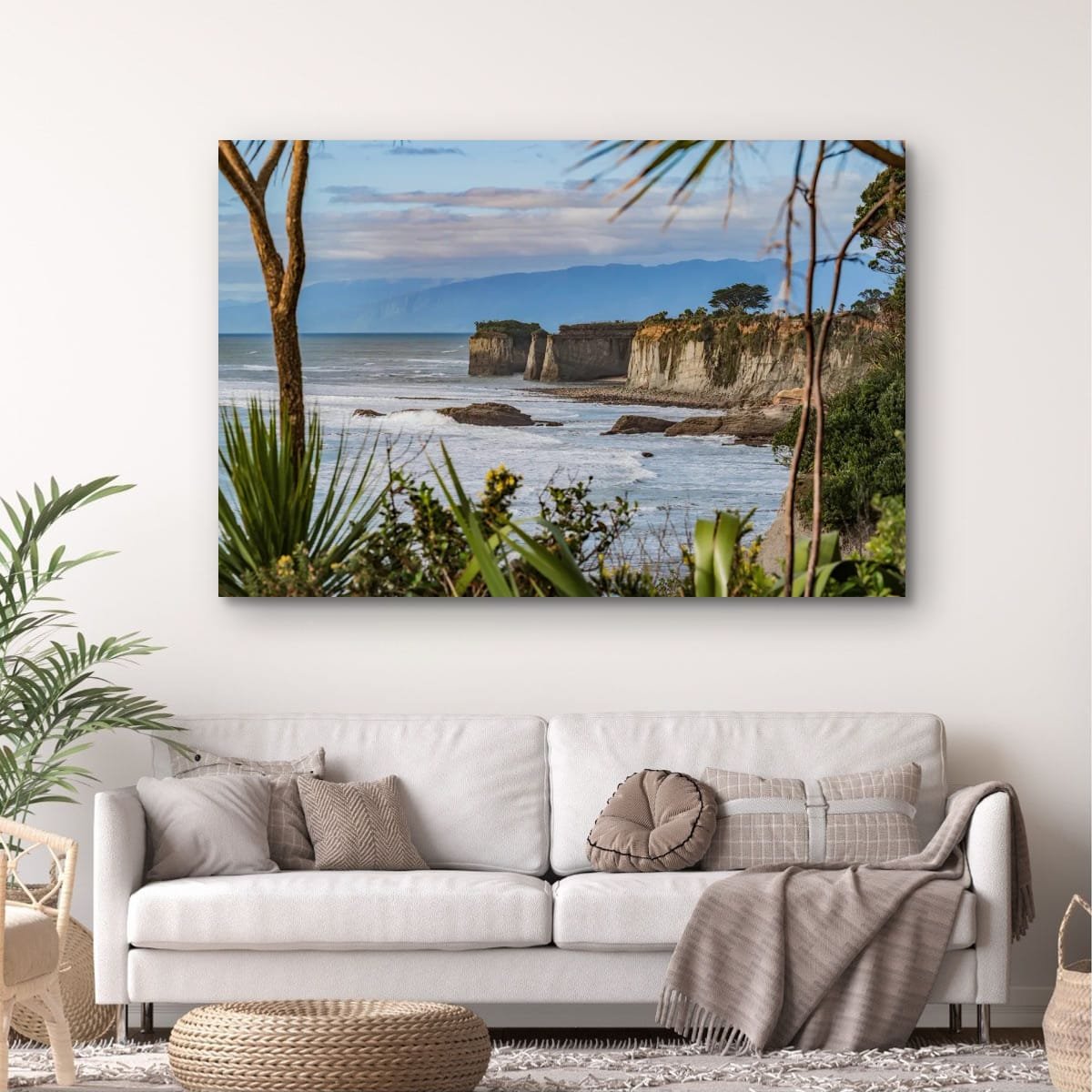 Coastal cliffs framed by native plants on the West Coast of New Zealand.