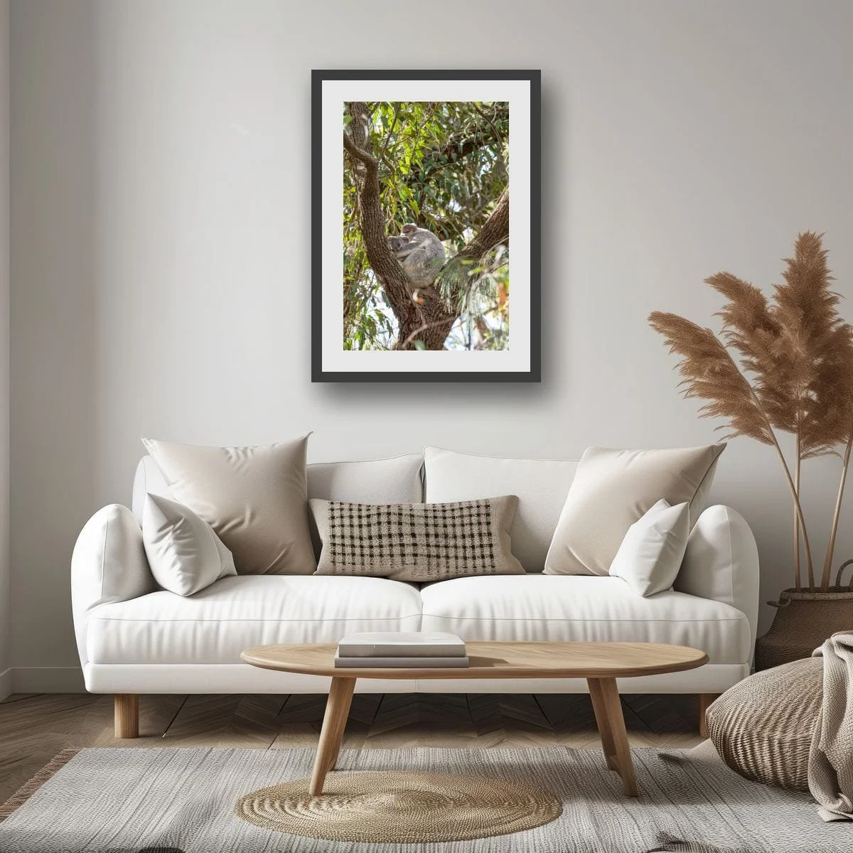 Koala resting comfortably in a tree surrounded by foliage.