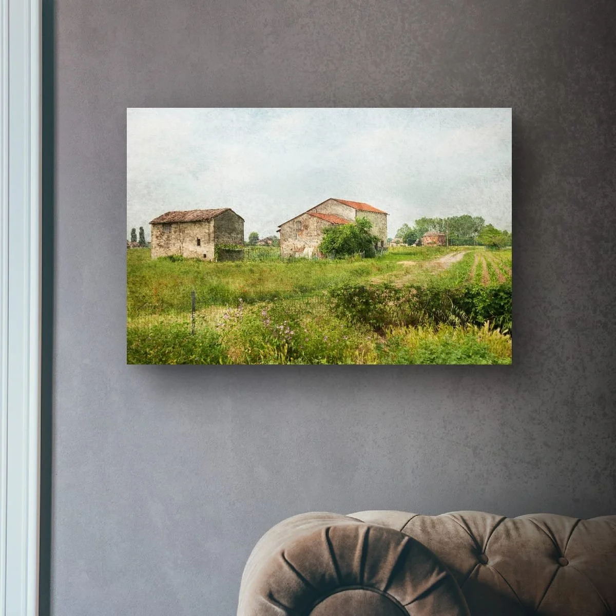 Rustic Italian farm buildings surrounded by green fields.