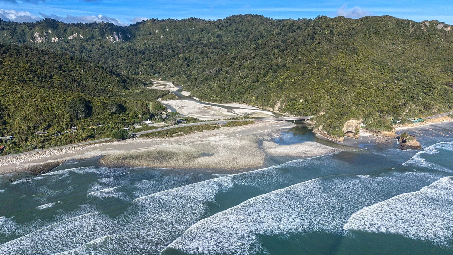 Aerial view of river mouth meeting the Tasman Sea on the West Coast.