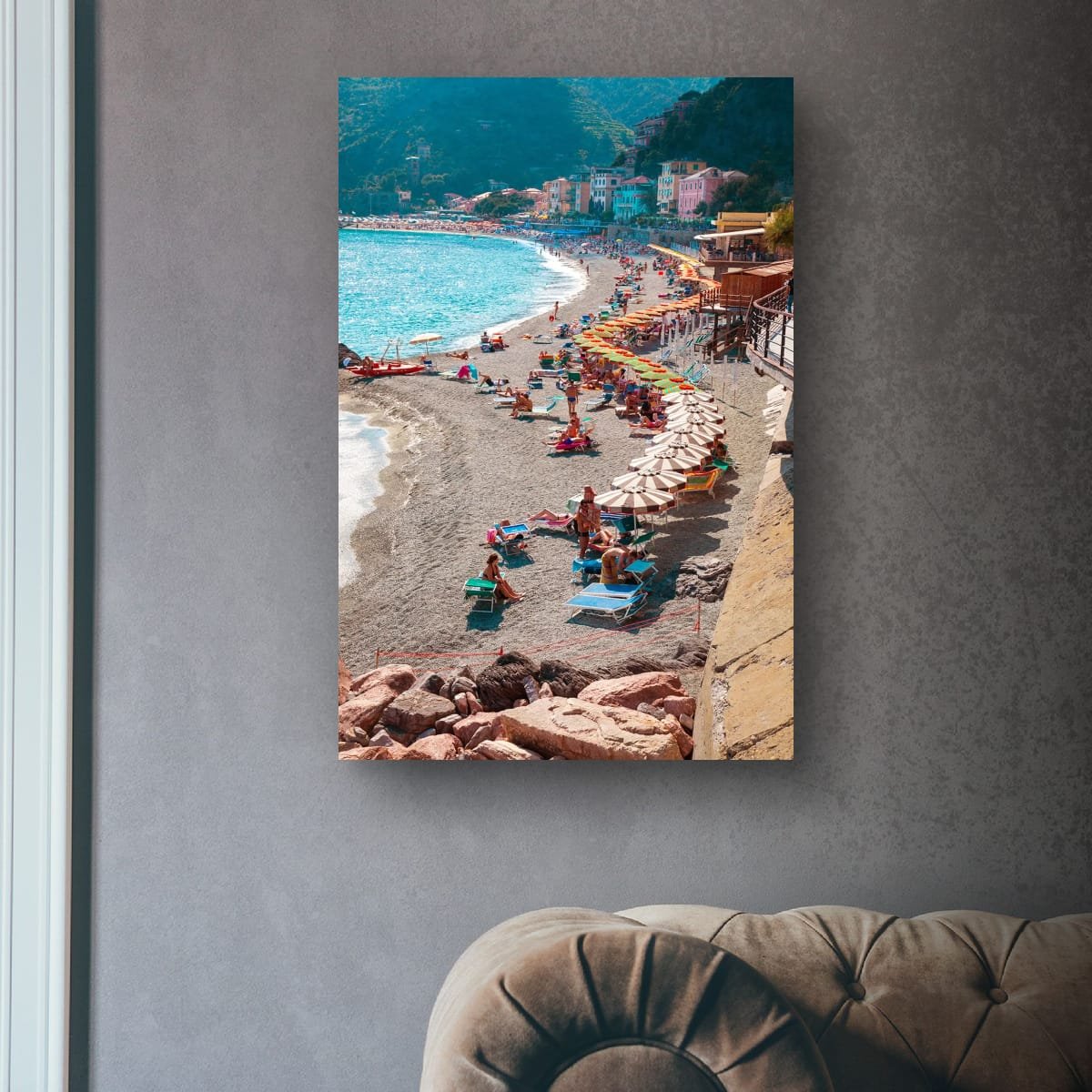 Busy Italian beach with colourful umbrellas and sunbathers.