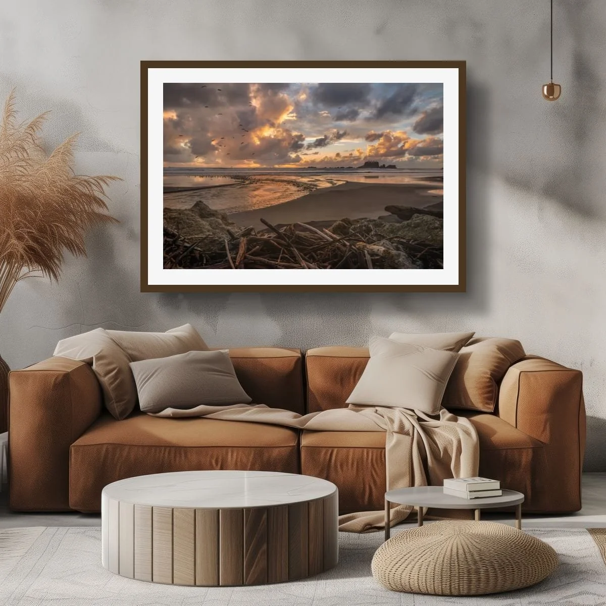 Flock of seabirds flying over a golden coastal sunset with stream, driftwood, wet sand and offshore rock formations.