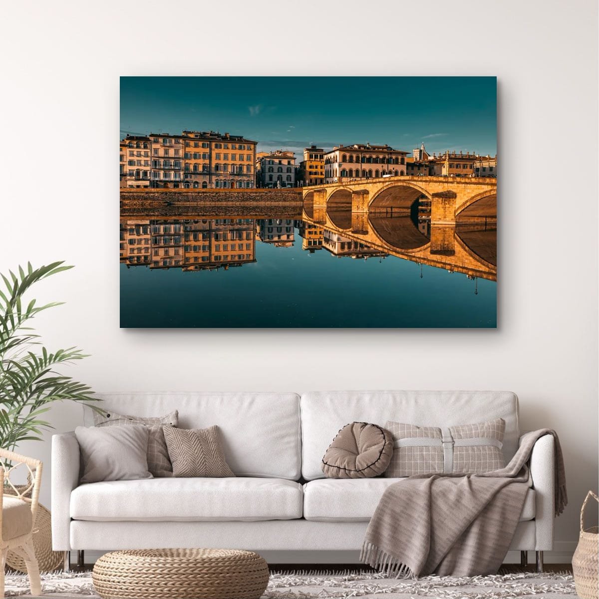 Florence bridge reflected in the Arno River at golden hour, Italy.
