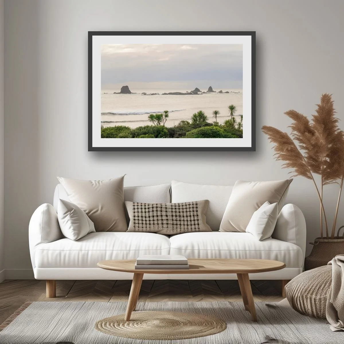 Morning light over sea stacks framed by native coastal plants.
