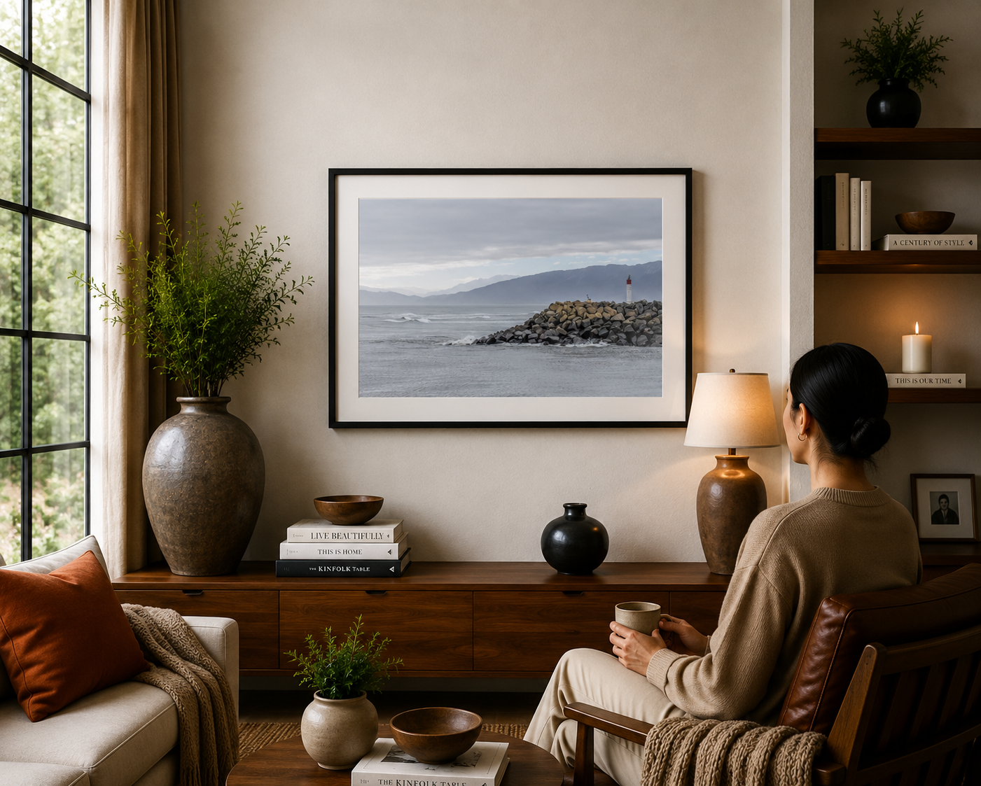 Beacon on a rocky breakwater with mountains beyond on New Zealand's West Coast.