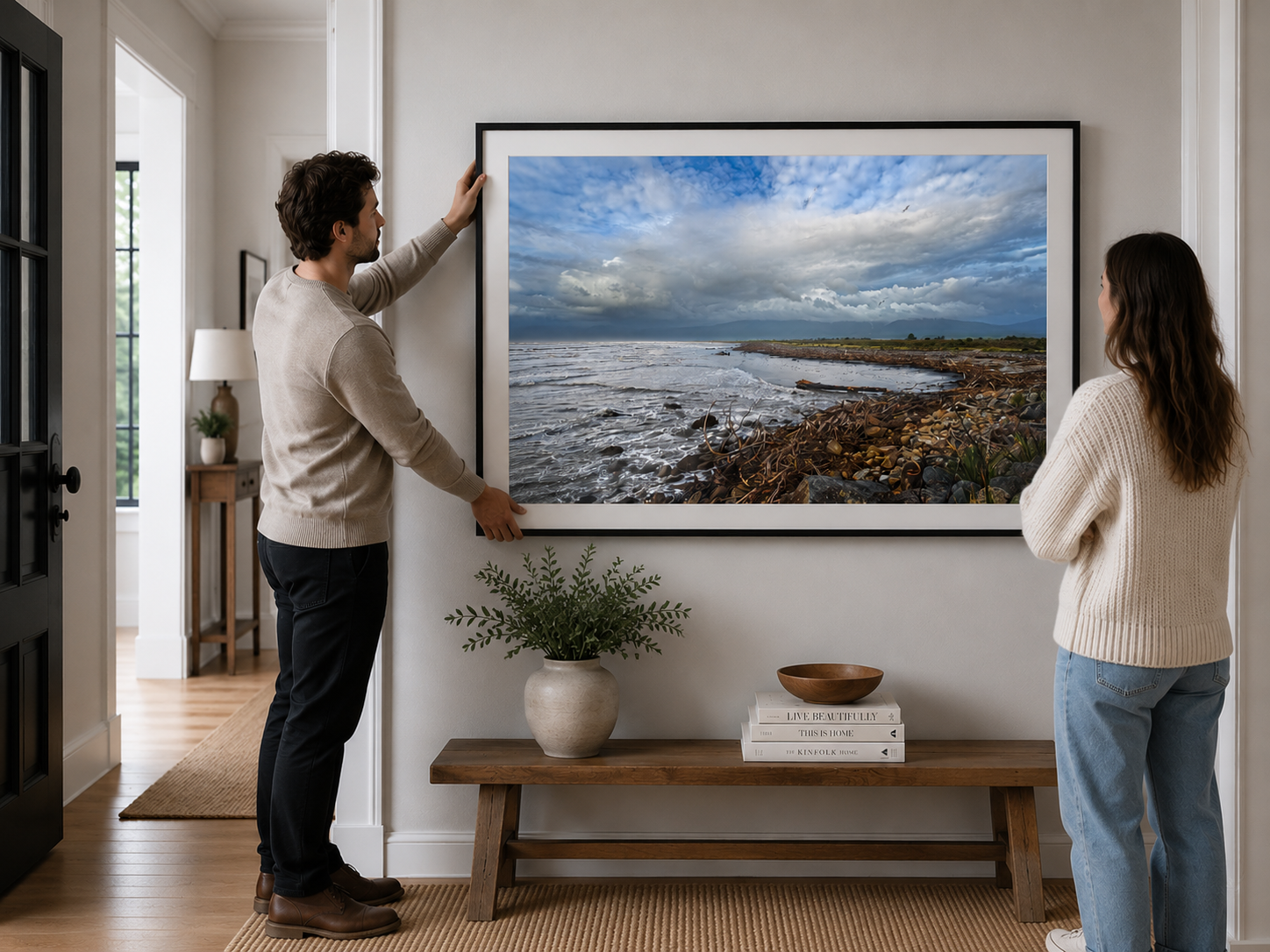 Fine art coastal photograph featuring driftwood, rocky shoreline and dramatic clouds along the New Zealand West Coast.