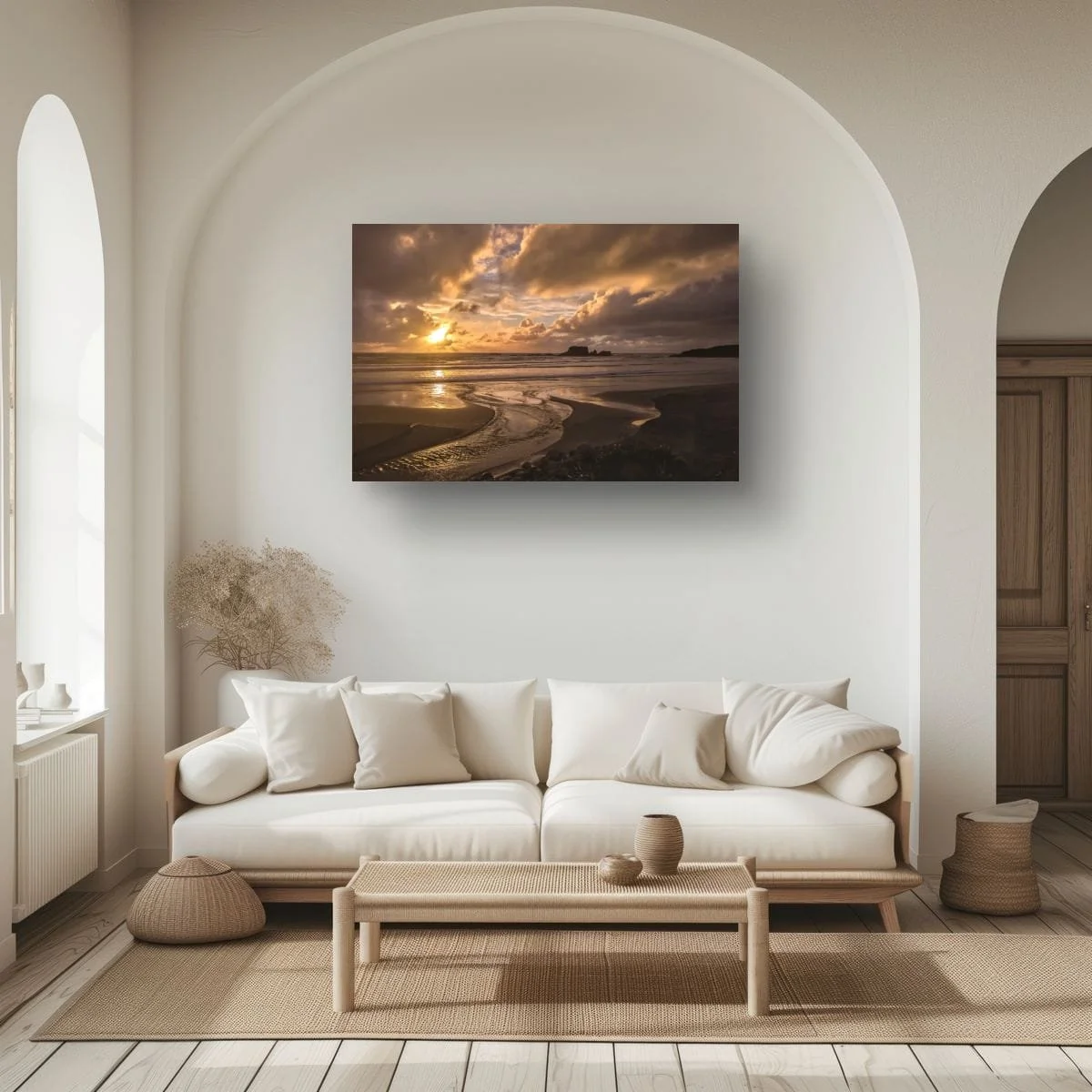 Golden sunset reflected in a winding beach stream beneath dramatic clouds with distant sea stacks.