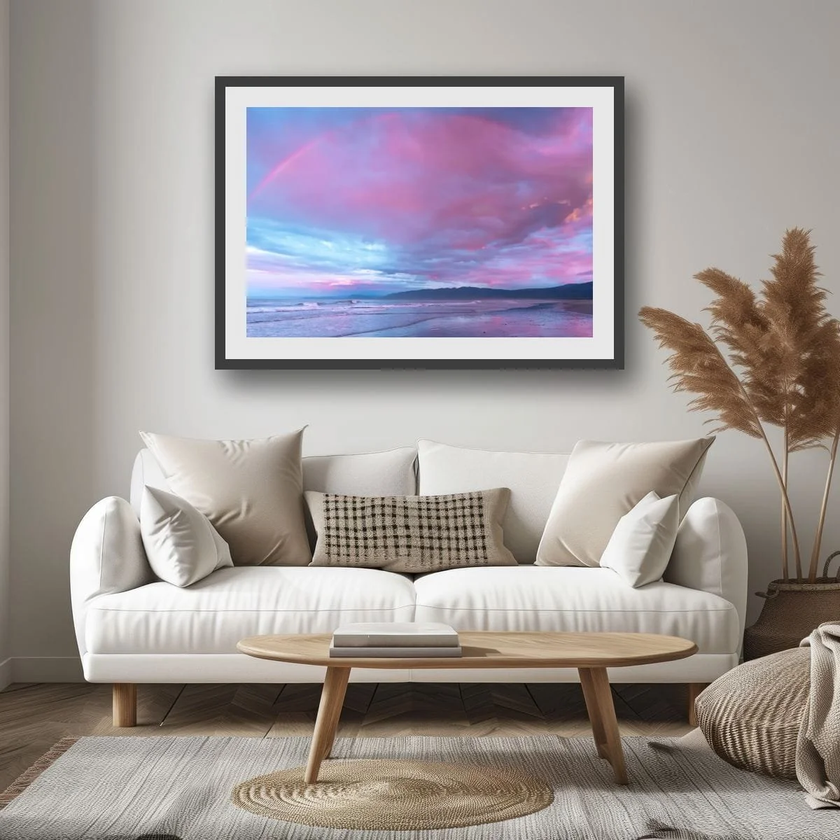 Rainbow above a West Coast beach with pink clouds.
