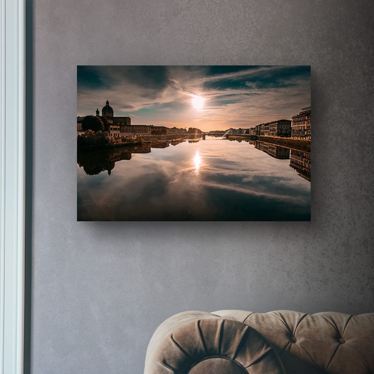 Florence skyline reflected in the Arno River beneath a glowing Tuscan sky.