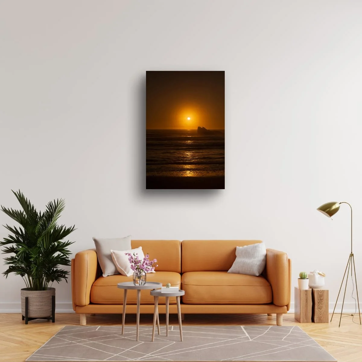 Warm orange sunset over the Tasman Sea with silhouetted sea stack and gentle waves.