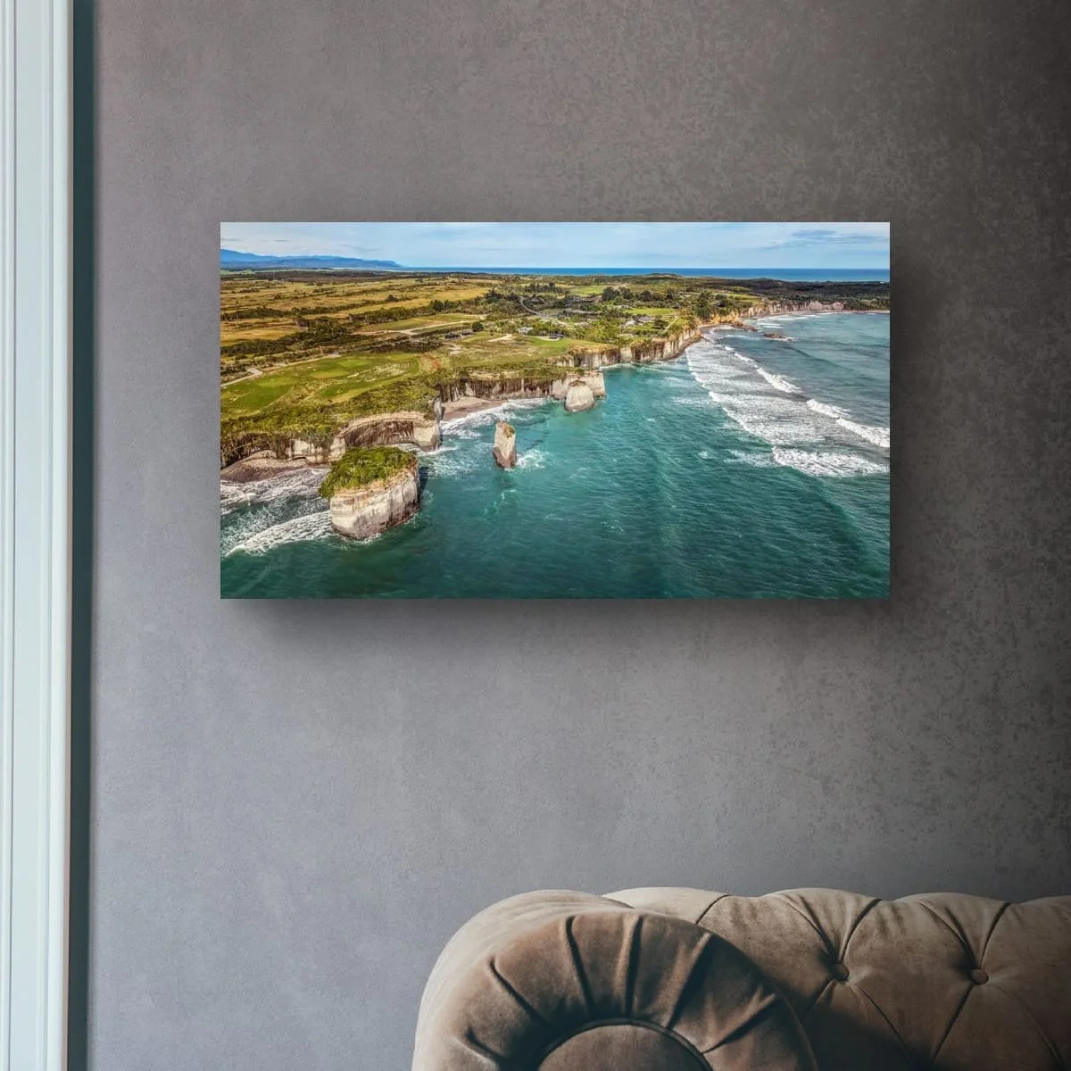 Aerial view of West Coast cliffs and ocean waves along the shoreline.