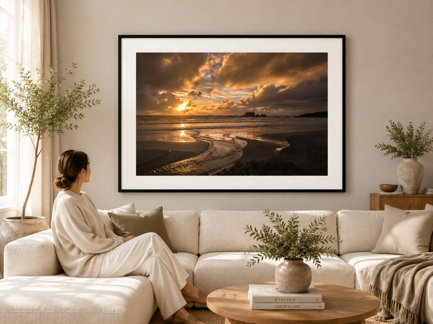 Golden sunset reflected in a winding beach stream beneath dramatic clouds with distant sea stacks.