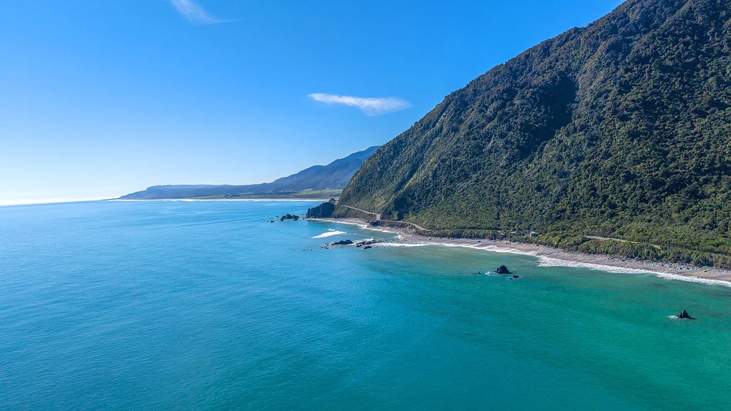 Aerial view of rugged West Coast coastline and ocean.