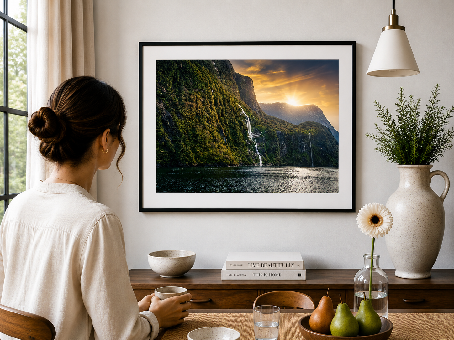 Waterfalls and cliffs in Milford Sound illuminated by sunlight.