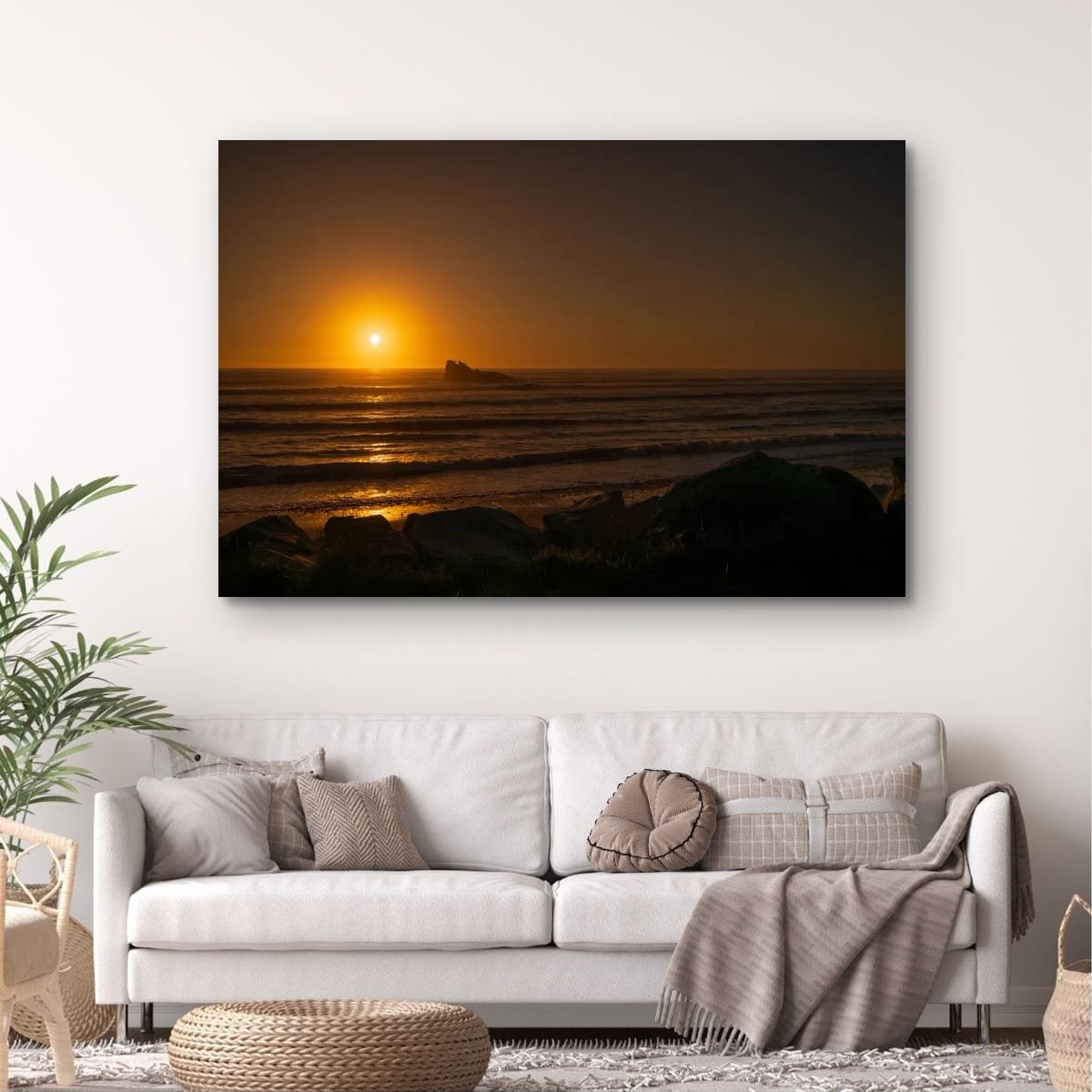 Golden sunset reflecting across the Tasman Sea with offshore rock formation.