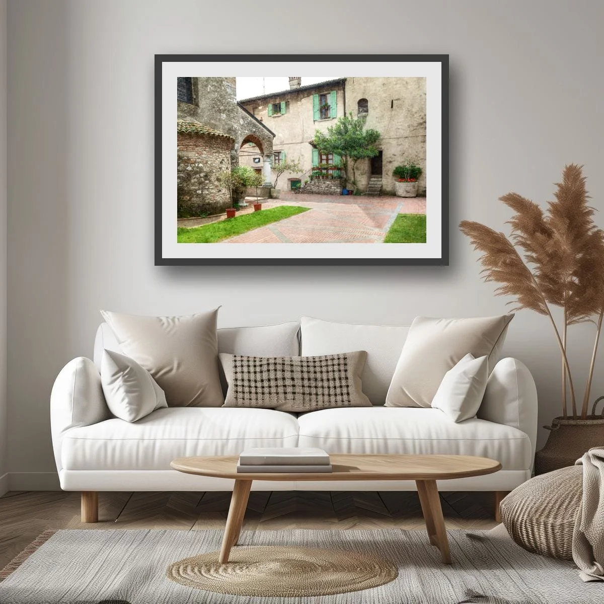 Quiet Tuscan courtyard with stone walls, potted plants and historic architecture.