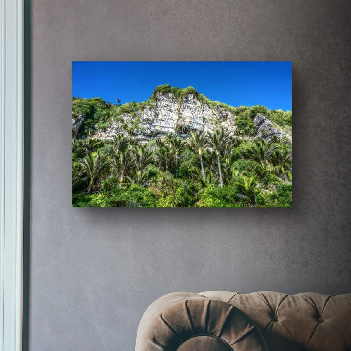 Limestone cliffs towering above native nikau palms.