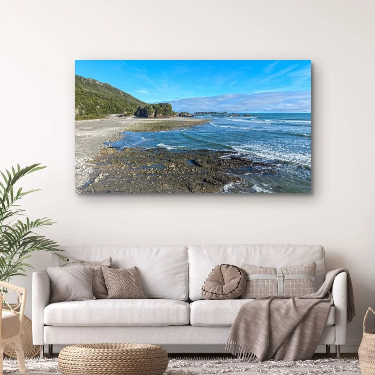 Coastal river mouth meeting the Tasman Sea beneath native forest-covered hills.