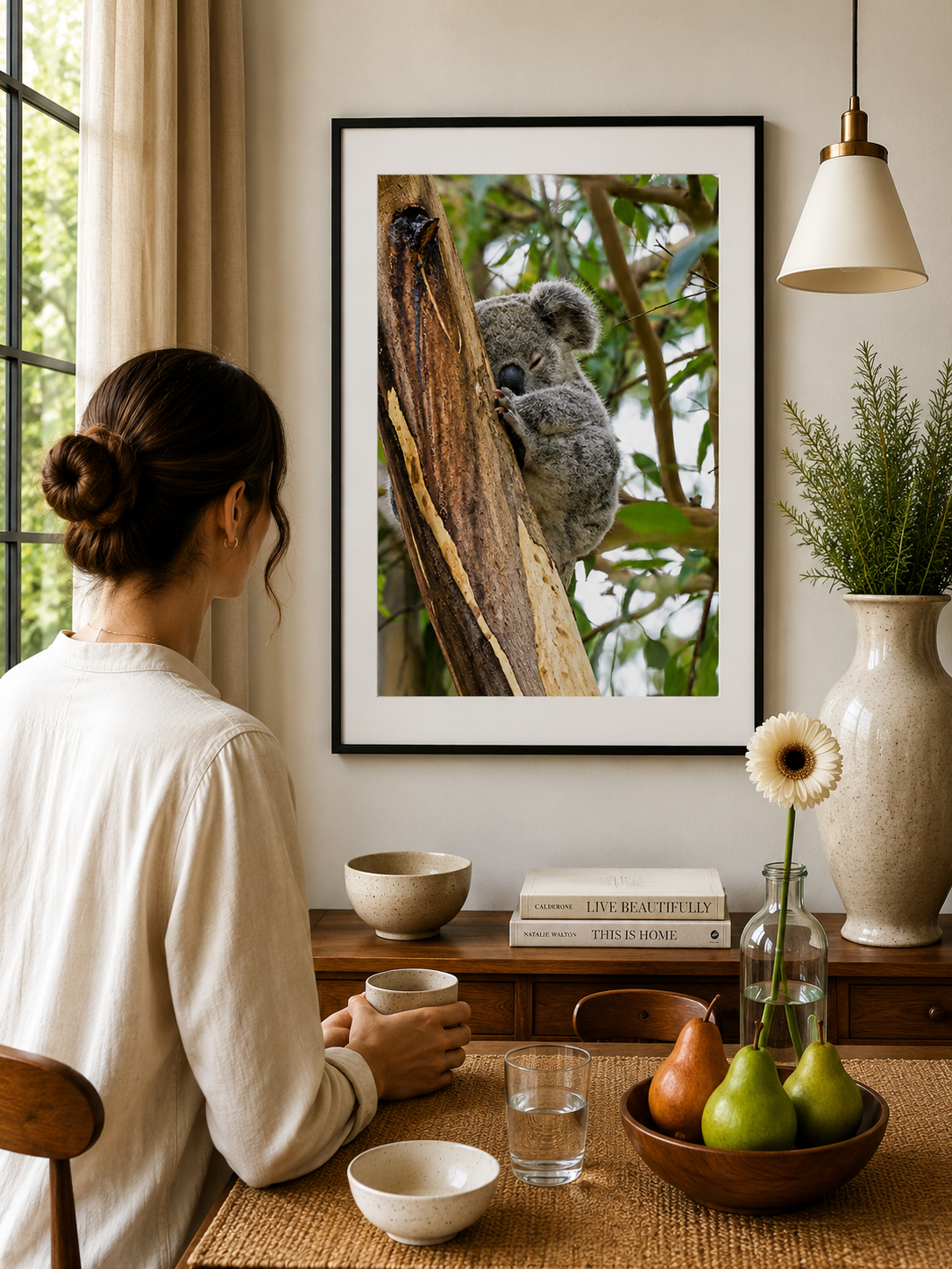 Young koala sleeping on a eucalyptus tree trunk.