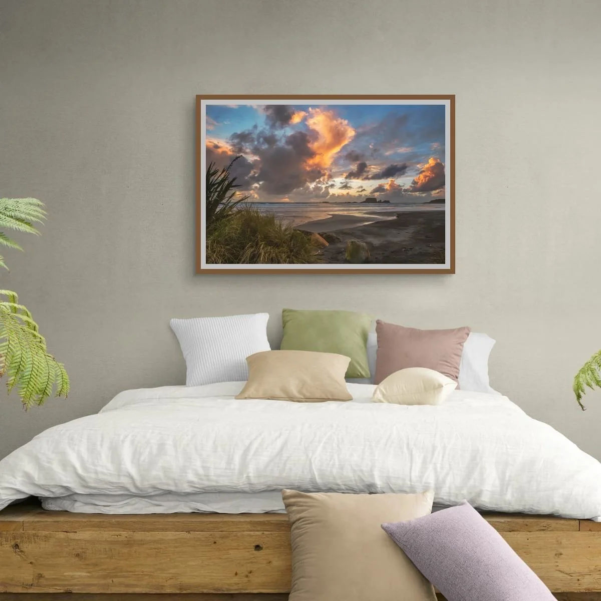 Golden sunset clouds above a West Coast beach with flax, wet sand, ocean waves and rocky sea stacks.