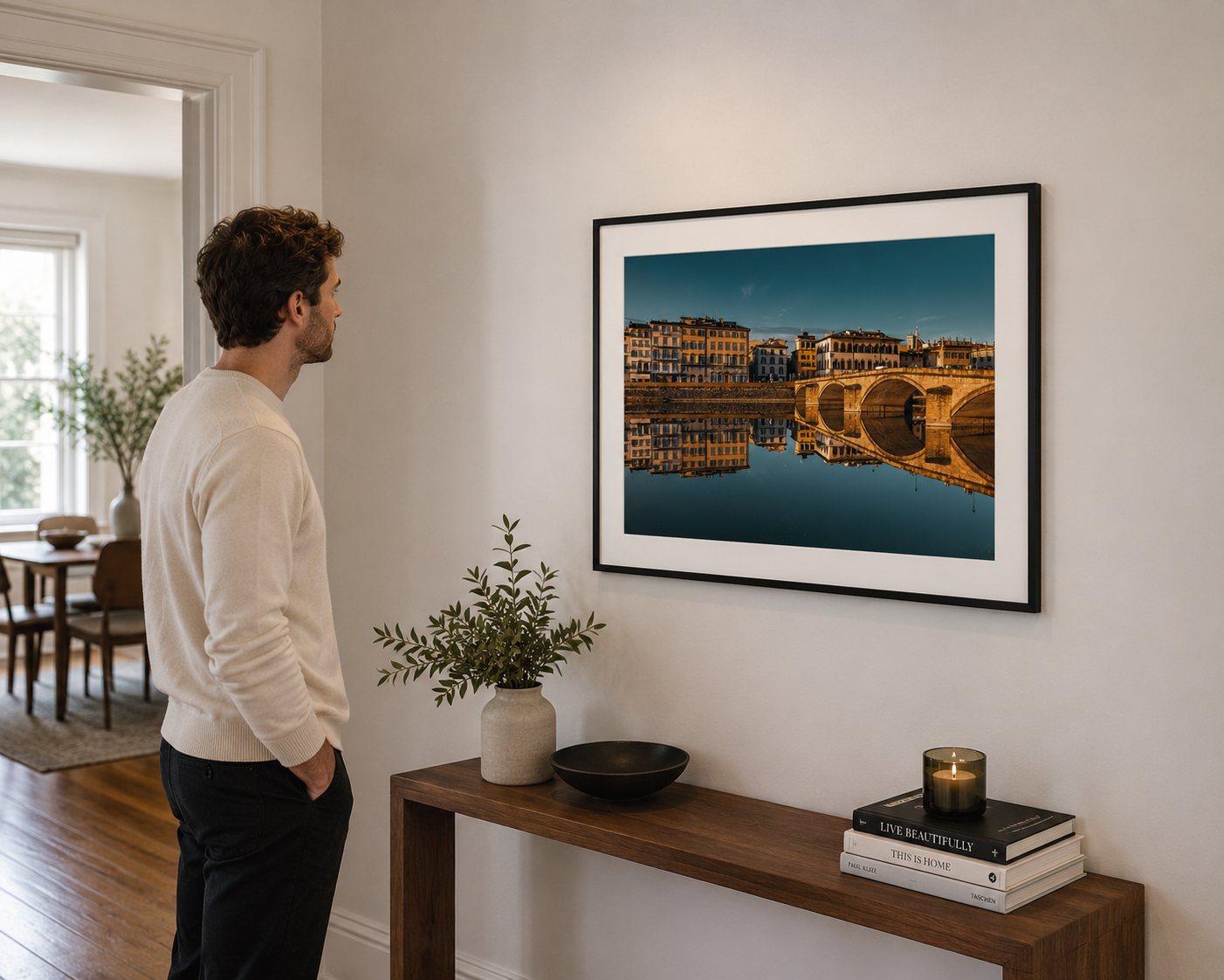 Florence bridge reflected in the Arno River at golden hour, Italy.