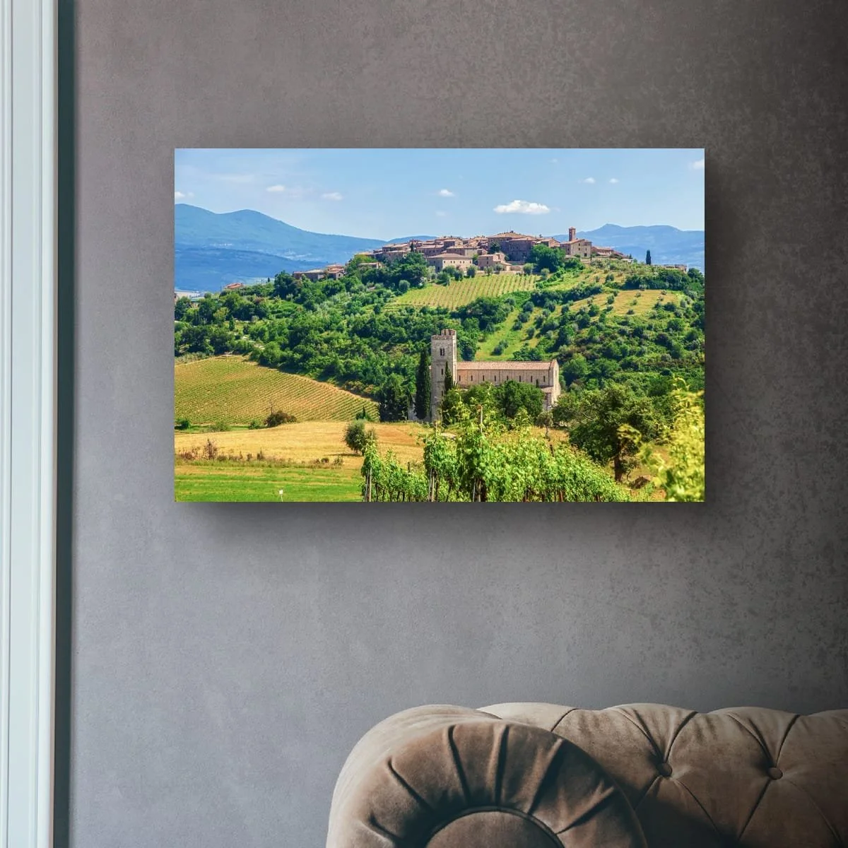 Tuscan hilltop village overlooking vineyards and countryside.