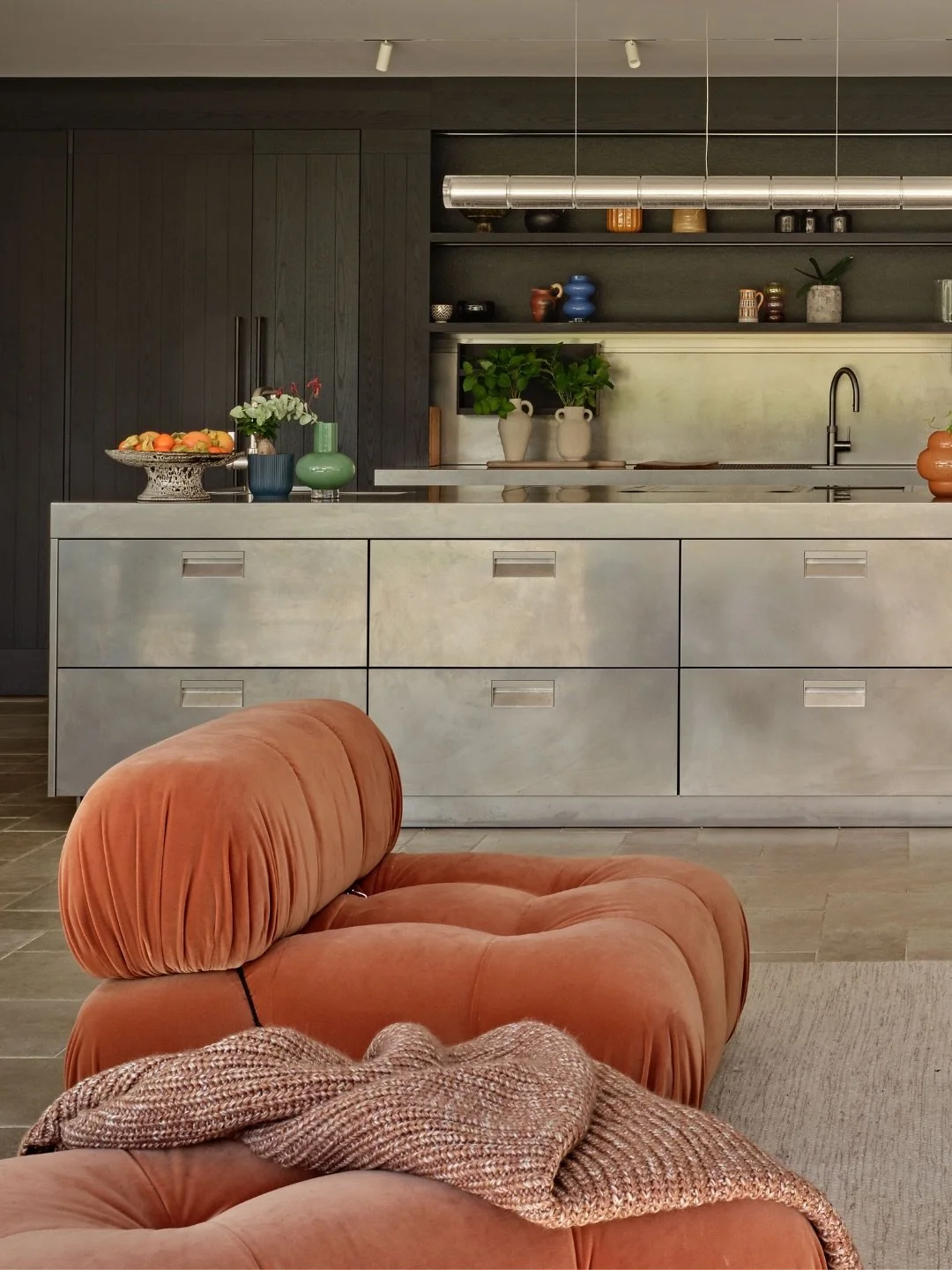 Stainless steel has a reputation for coldness - the professional kitchen, the laboratory, the canteen. Used well, in the right company, it does something else entirely.

At our Country Modern project in the Surrey Hills, the kitchen island is clad in