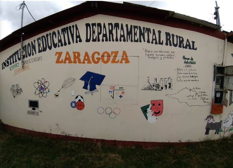 A mural on a wall of an educational institution in Zaragoza, highlighting rural and scientific education with icons of books, atoms, feathers, a computer, sports equipment, and laboratory glassware, along with a map of the local area.