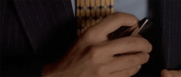 Close-up of a person's hand holding and using a smartphone.