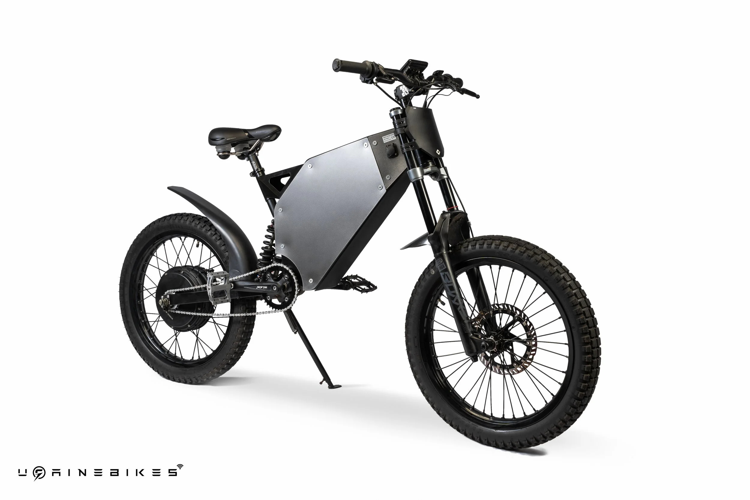Electric dirt bike with black tires, silver body panel, and black handlebars against a white background.